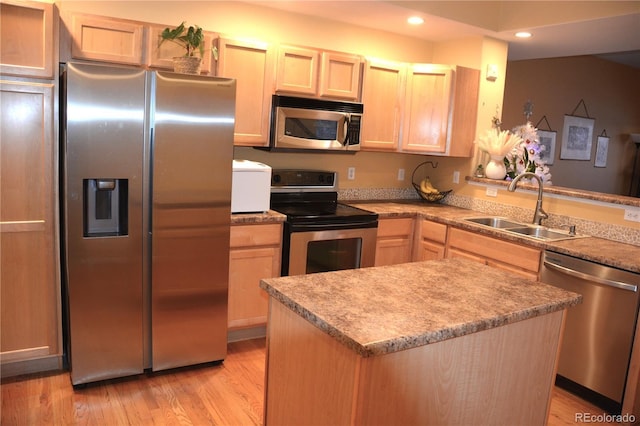 kitchen with light brown cabinetry, sink, light wood-type flooring, and appliances with stainless steel finishes