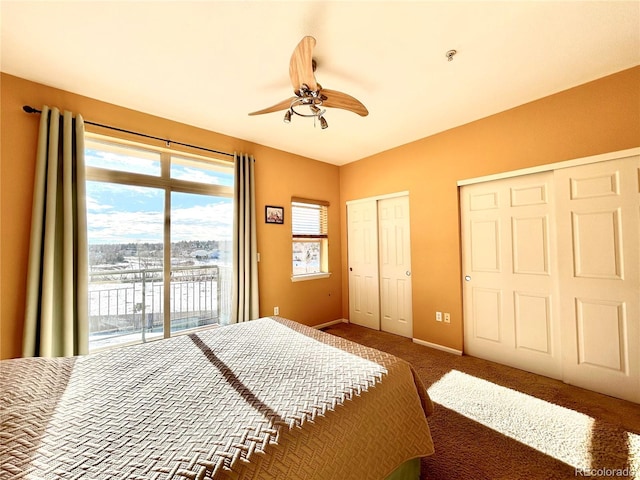 bedroom with multiple closets, carpet floors, access to exterior, and ceiling fan