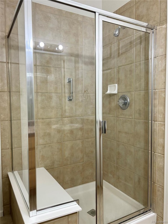 bathroom with a shower with shower door