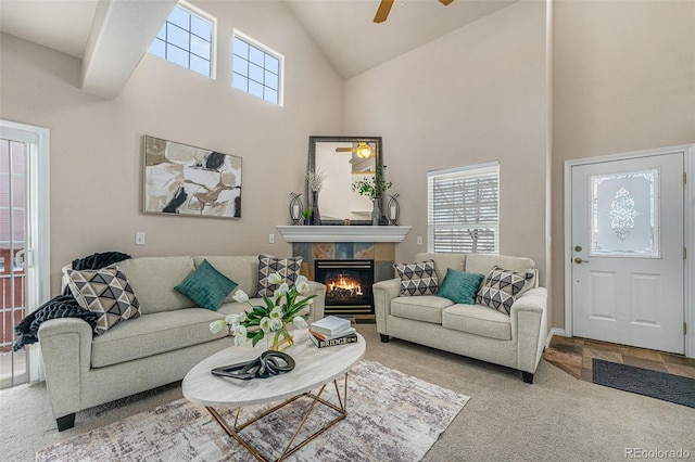 living room with plenty of natural light, carpet floors, high vaulted ceiling, and a fireplace