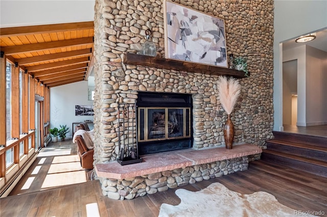 31607 Broadmoor Dr, Evergreen, CO 80439 - detailed view of wood finished floors, a glass covered fireplace, wooden ceiling with exposed beams, and baseboards