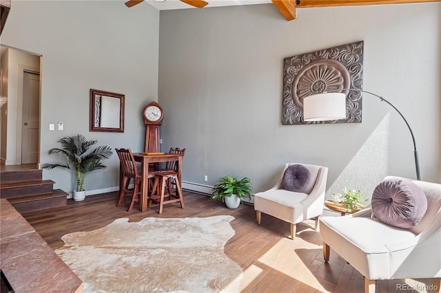 31607 Broadmoor Dr, Evergreen, CO 80439 - sitting room with wood finished floors, a ceiling fan, a high ceiling, stairs, and baseboards
