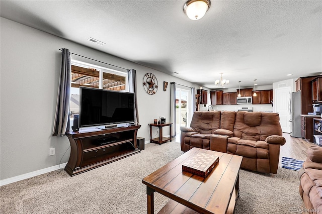10684 Calista Way, Fountain, CO 80817 - living area with a chandelier, light colored carpet, and a textured ceiling