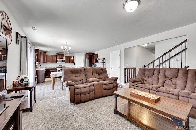 10684 Calista Way, Fountain, CO 80817 - living room featuring a chandelier, light wood-type flooring, stairs, and recessed lighting