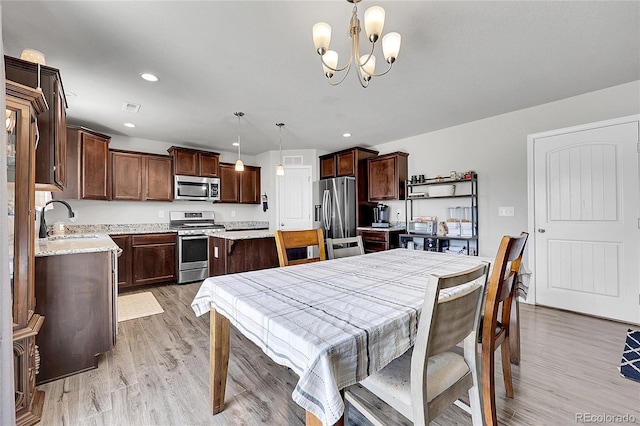 10684 Calista Way, Fountain, CO 80817 - dining area featuring light wood finished floors, a chandelier, and recessed lighting