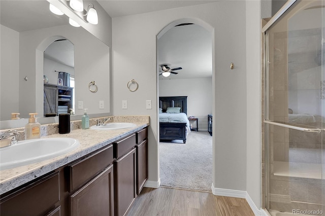 10684 Calista Way, Fountain, CO 80817 - bathroom featuring a ceiling fan, double vanity, a shower stall, and ensuite bath