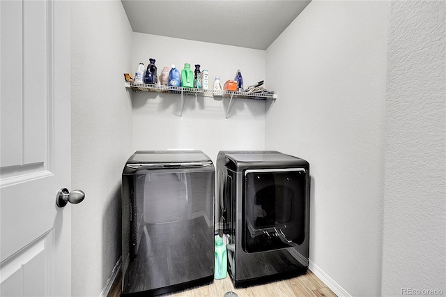 10684 Calista Way, Fountain, CO 80817 - washroom featuring independent washer and dryer and light wood-style flooring