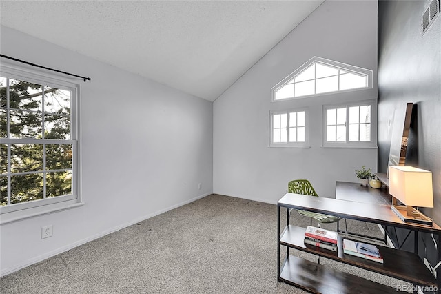 carpeted office featuring baseboards, visible vents, vaulted ceiling, and a textured ceiling