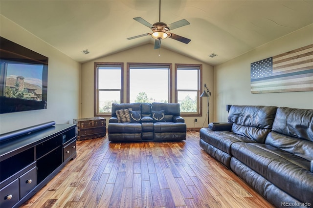 living room with ceiling fan, lofted ceiling, and light wood-type flooring