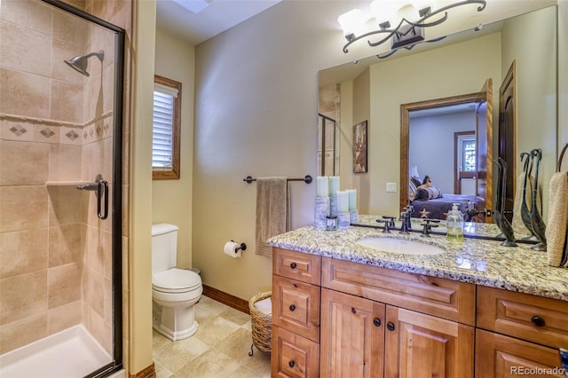 bathroom with vanity, toilet, and a shower with shower door