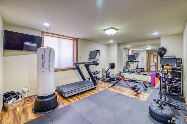 exercise room with hardwood / wood-style flooring