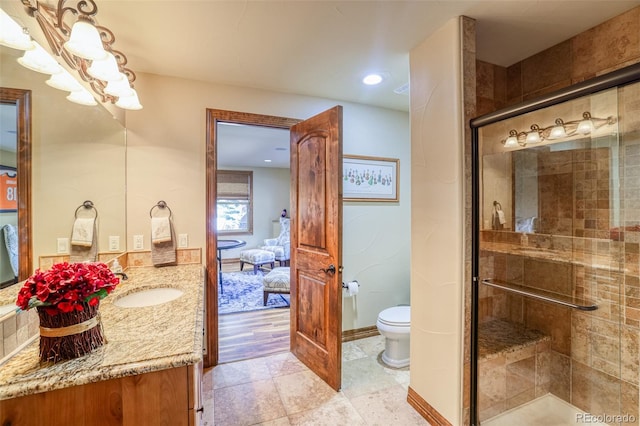 bathroom with vanity, toilet, and walk in shower