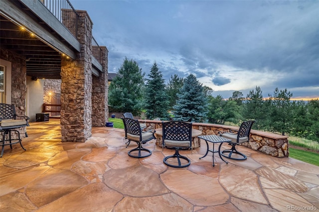 view of patio terrace at dusk