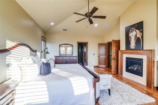 bedroom with ceiling fan, lofted ceiling, and light hardwood / wood-style flooring