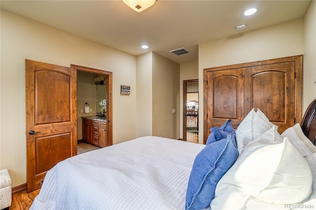 bedroom with dark hardwood / wood-style floors