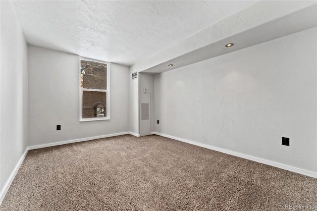 empty room featuring carpet floors and a textured ceiling