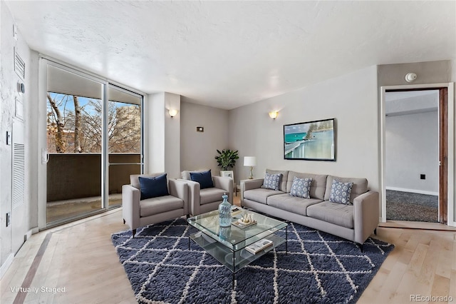 living area with baseboards and light wood-style flooring