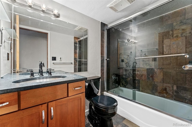 bathroom featuring visible vents, shower / bath combination with glass door, toilet, and vanity