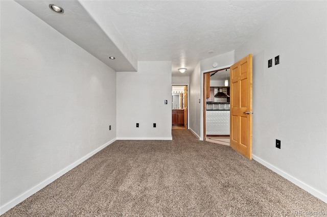 unfurnished living room featuring baseboards, carpet flooring, and recessed lighting