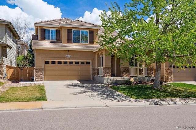 view of front of home with stone siding, an attached garage, driveway, and stucco siding