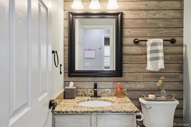 half bathroom with toilet and vanity