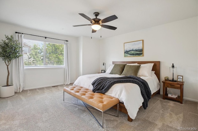 carpeted bedroom with baseboards and a ceiling fan