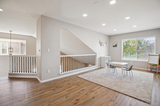 living area featuring wood finished floors, recessed lighting, and baseboards
