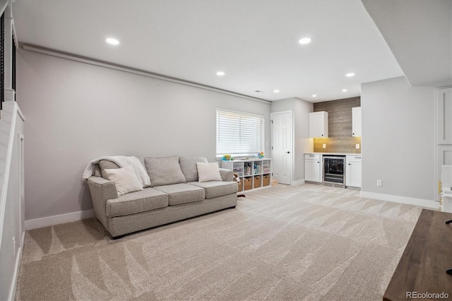 living area with beverage cooler, light carpet, recessed lighting, and baseboards