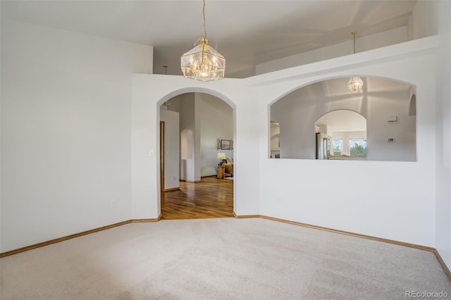 9950 Keating Dr, Peyton, CO 80831 - unfurnished room with carpet flooring, a chandelier, and arched walkways