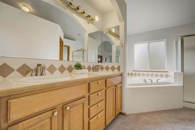 9950 Keating Dr, Peyton, CO 80831 - bathroom with a stall shower, double vanity, a bath, and tasteful backsplash