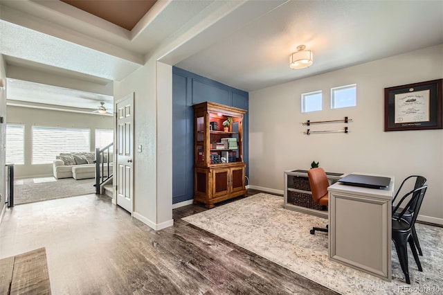office area featuring baseboards, ceiling fan, and wood finished floors