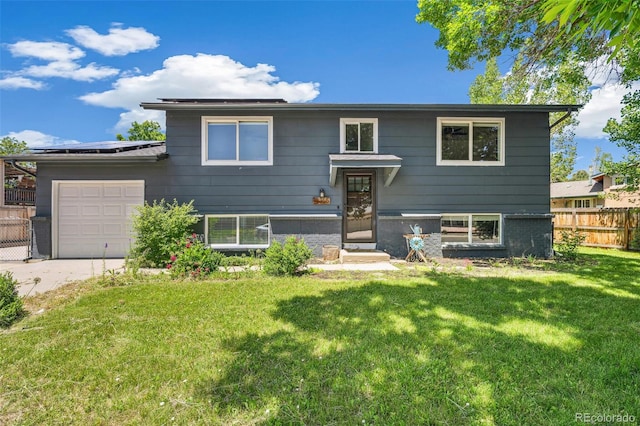 18355 W 59th Dr, Golden, CO 80403 - raised ranch featuring roof mounted solar panels, concrete driveway, and a garage
