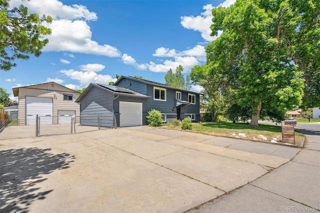 18355 W 59th Dr, Golden, CO 80403 - view of front of house featuring a garage, roof mounted solar panels, and a gate