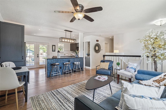 18355 W 59th Dr, Golden, CO 80403 - living room featuring a textured ceiling, wood finished floors, a ceiling fan, and french doors