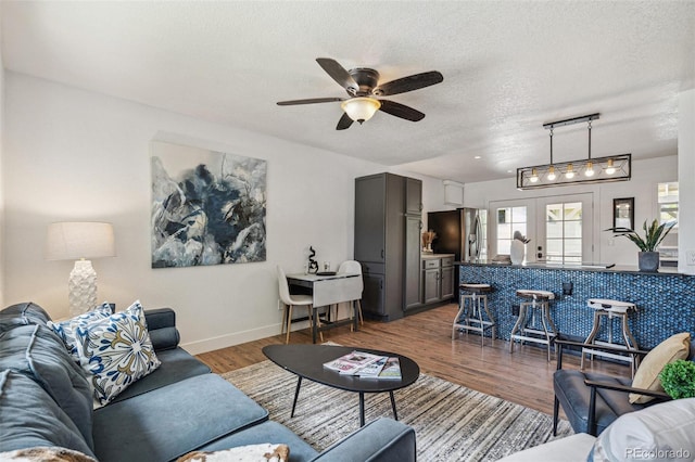 18355 W 59th Dr, Golden, CO 80403 - living room with a textured ceiling, a ceiling fan, and wood finished floors