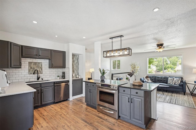 18355 W 59th Dr, Golden, CO 80403 - kitchen featuring electric range, dishwasher, open floor plan, decorative backsplash, and gray cabinets