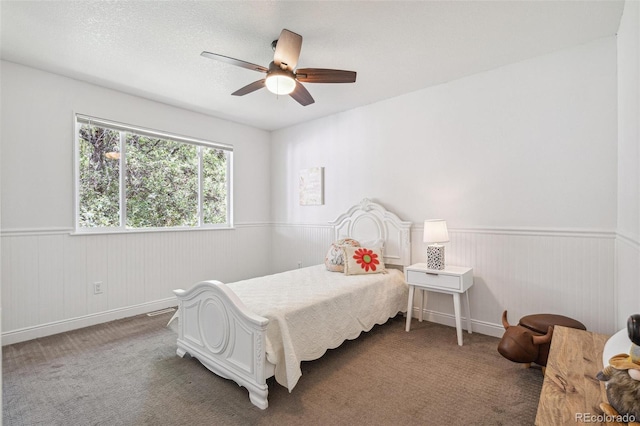 18355 W 59th Dr, Golden, CO 80403 - bedroom with wainscoting, carpet flooring, and ceiling fan