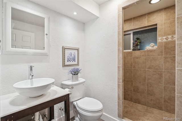 18355 W 59th Dr, Golden, CO 80403 - full bathroom featuring a textured wall, vanity, tiled shower, and recessed lighting