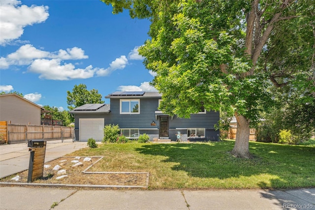 18355 W 59th Dr, Golden, CO 80403 - view of front of home featuring a garage, roof mounted solar panels, and driveway