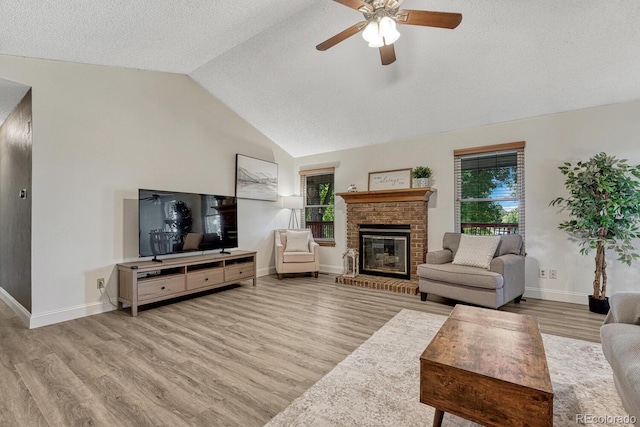 1572 W Long Ave, Littleton, CO 80120 - living area with healthy amount of natural light, wood finished floors, lofted ceiling, ceiling fan, and a brick fireplace