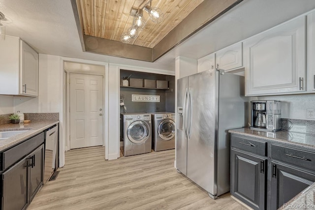 1572 W Long Ave, Littleton, CO 80120 - kitchen featuring independent washer and dryer, wood ceiling, stainless steel appliances, white cabinetry, and light wood-style floors
