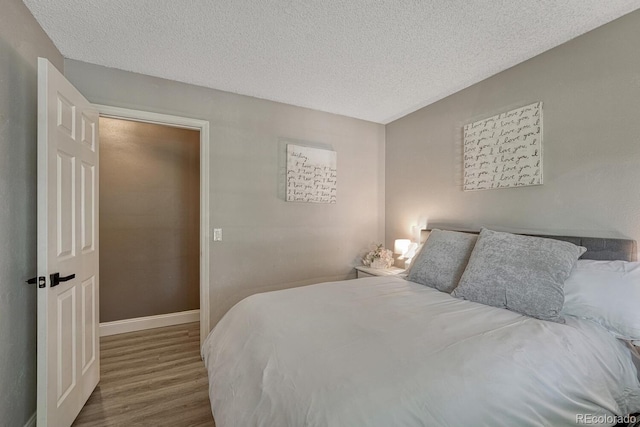 1572 W Long Ave, Littleton, CO 80120 - bedroom with wood finished floors and a textured ceiling