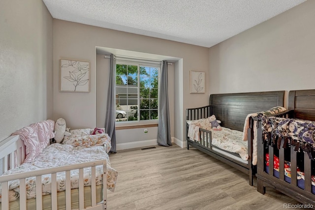 1572 W Long Ave, Littleton, CO 80120 - bedroom with wood finished floors and a textured ceiling