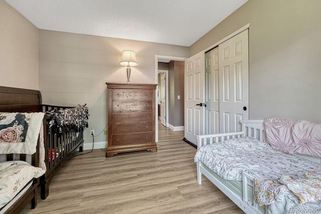 1572 W Long Ave, Littleton, CO 80120 - bedroom featuring light wood-type flooring, a closet, and a textured ceiling