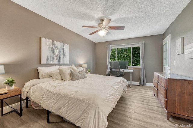 1572 W Long Ave, Littleton, CO 80120 - bedroom with light wood-type flooring, a textured ceiling, and ceiling fan
