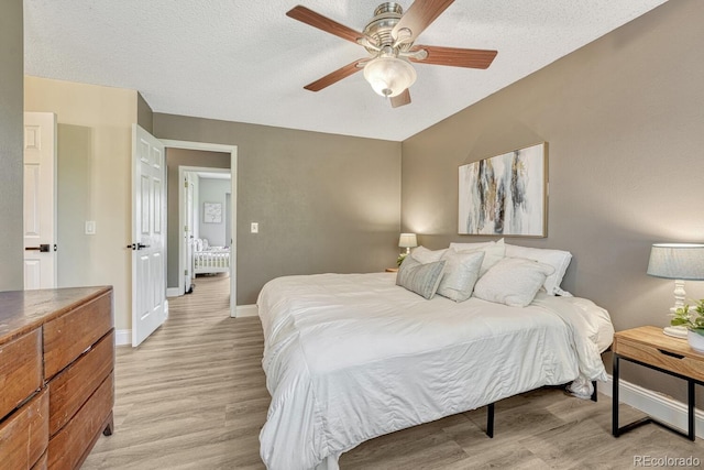 1572 W Long Ave, Littleton, CO 80120 - bedroom featuring light wood-style floors, a ceiling fan, and a textured ceiling