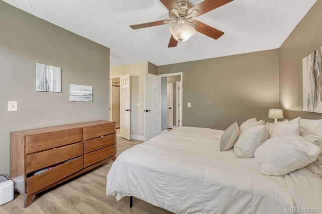 1572 W Long Ave, Littleton, CO 80120 - bedroom with light wood finished floors, a ceiling fan, and a textured ceiling