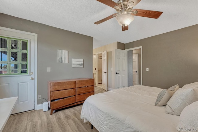 1572 W Long Ave, Littleton, CO 80120 - bedroom featuring light wood finished floors, ceiling fan, and a textured ceiling