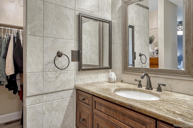1572 W Long Ave, Littleton, CO 80120 - bathroom with vanity, tile walls, and a spacious closet