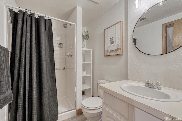 1572 W Long Ave, Littleton, CO 80120 - full bath featuring a shower stall, vanity, and a textured wall